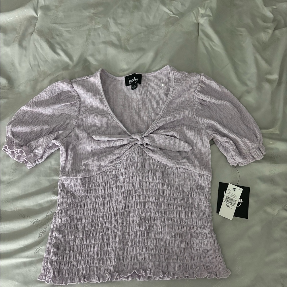 By & by purple top with bow detailing. Size S.
